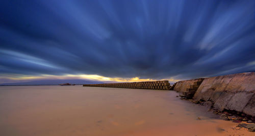 Scenic view of beach against sky at night