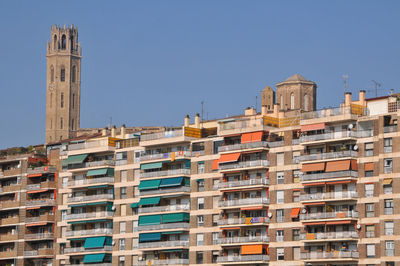 Low angle view of buildings against clear blue sky