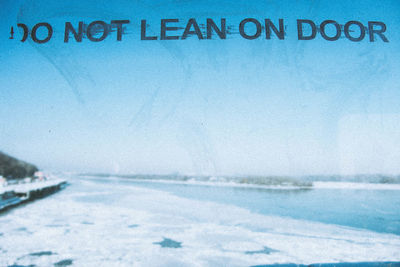 Close-up of white text on blue wall