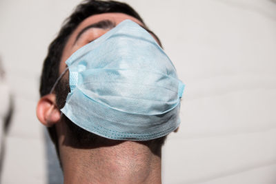 Close up portrait of man breathing with face mask