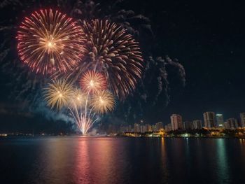 Low angle view of firework display at night