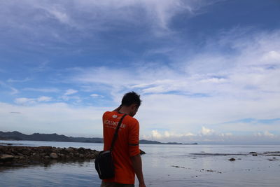 Man looking at sea against sky