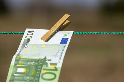 100 euro banknote on a clothesline. money laundering theme.