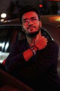 Young man sitting in car