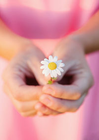 Close-up of woman holding white flower