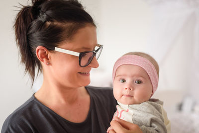 Close-up of mother and daughter at home