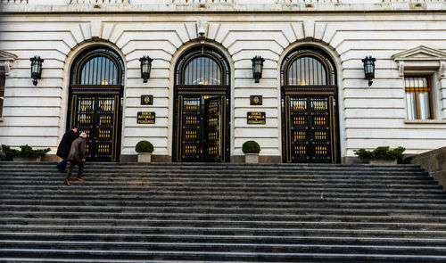 People walking on staircase of building