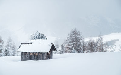 Winter paradise, small hut covered in snow in the italian alps.