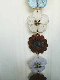 Close-up of decoration hanging against white wall