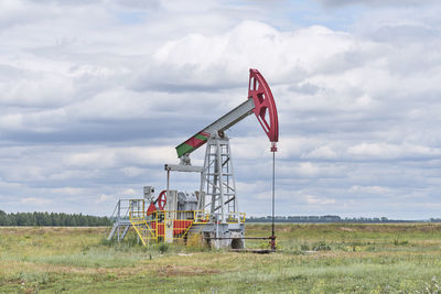 Oil rocking chair in field,bashkortostan,russia. pumping machine for production of petroleum