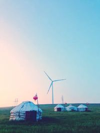 Wind turbines on grassy field