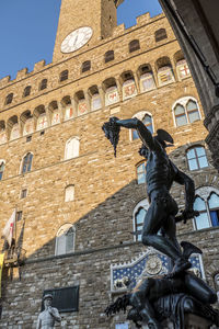 Low angle view of statue against historic building