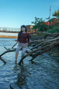 Full length of young woman against clear sky