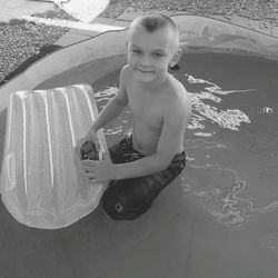 Portrait of smiling boy playing in water