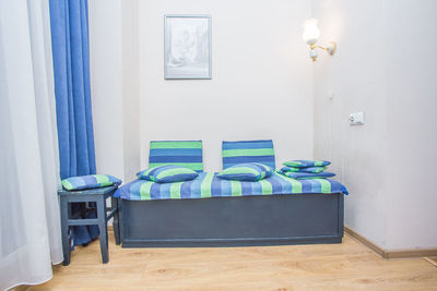 Empty chair against blue wall at home