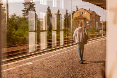 Full length of man standing on railroad station platform