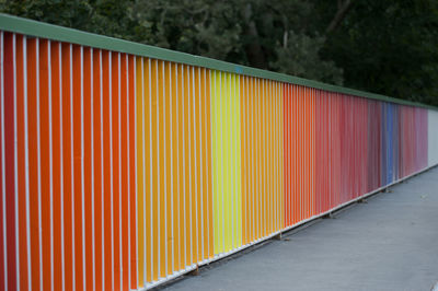 Colorful wall on sidewalk against trees