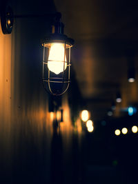 Close-up of illuminated light bulb on wall