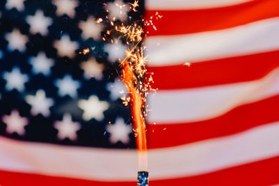 Full frame shot of american flag with sparkler