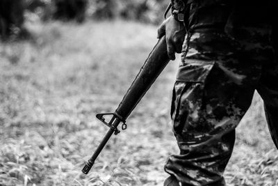 Close-up of man with arms outstretched standing on field