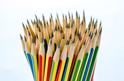 Close-up of colored pencils against white background