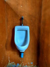 Close-up of wine glasses on wall at home