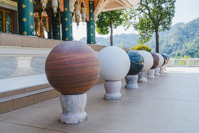 Row of objects on footpath by building