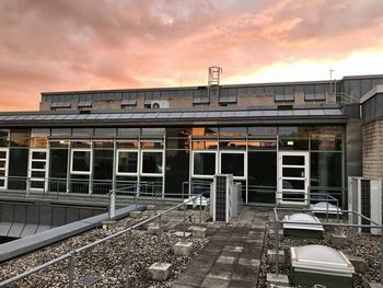 Train at railroad station against sky during sunset