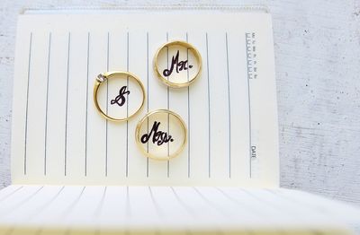 High angle view of rings with text on diary