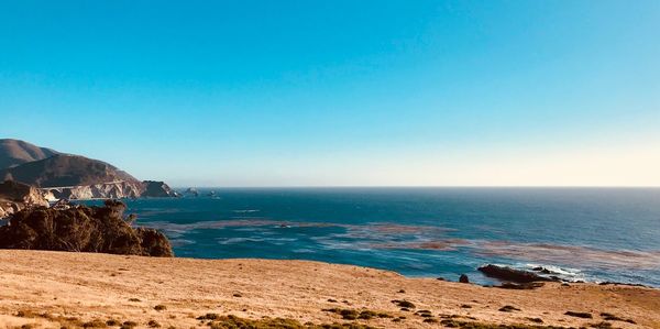 Scenic view of sea against clear blue sky