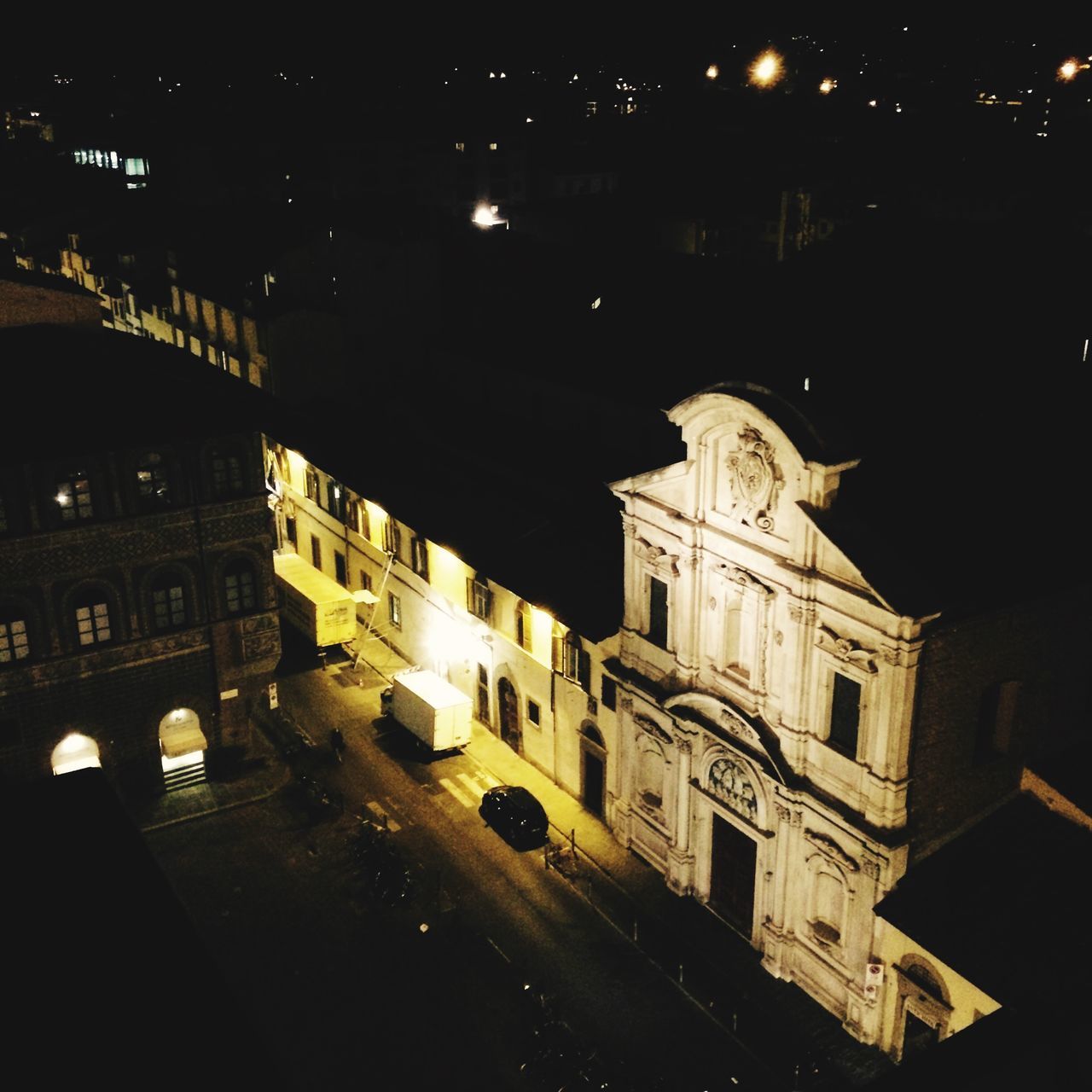 night, illuminated, building exterior, architecture, built structure, transportation, street, city, car, road, land vehicle, city street, city life, mode of transport, dark, street light, high angle view, traffic, outdoors, road marking