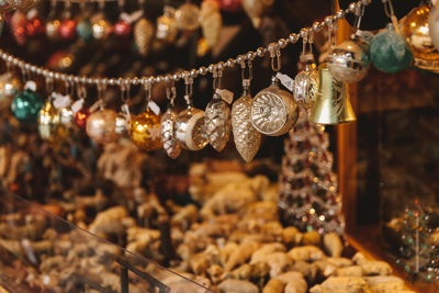 Close-up of decorations hanging in store for sale