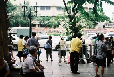 Rear view of people on street in city