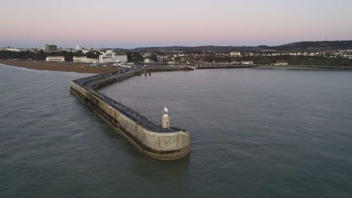 High angle view of river by buildings against sky