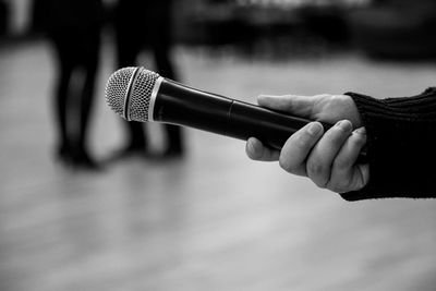 Close-up of person holding microphone