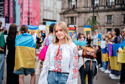 Glasgow, scotalnd - july 30, 2022 a blonde girl in traditional ukrainian shirt at anti-russia