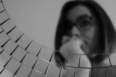 Close-up of woman seen through glass container