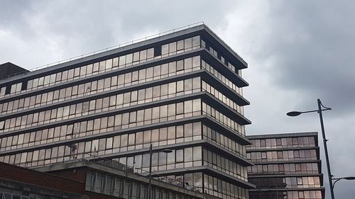 Low angle view of office building against sky