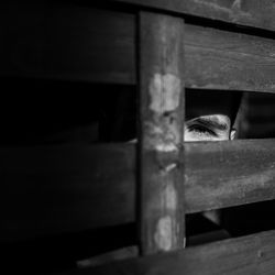 Close-up of man looking through window