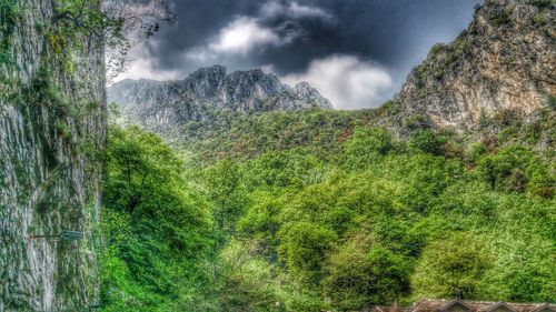 Scenic view of mountains against cloudy sky