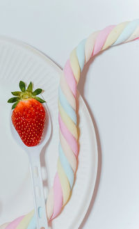 High angle view of strawberries on table against white background