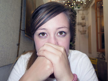 Close-up portrait of woman at home