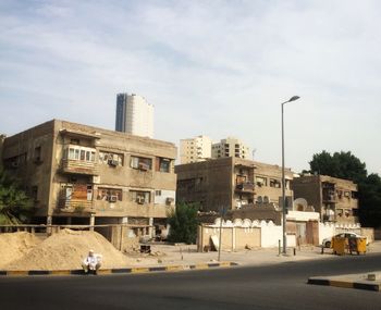 City street and buildings against sky