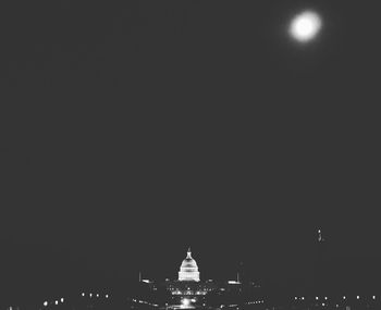 Illuminated city against sky at night