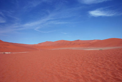 Scenic view of desert against blue sky