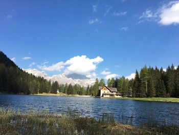 Scenic view of lake in forest against sky