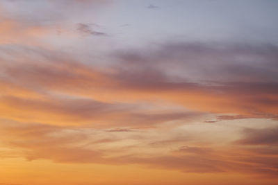 Low angle view of cloudy sky at sunset