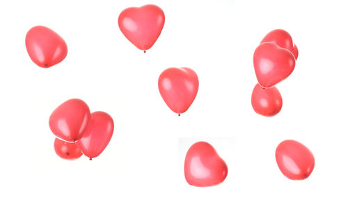 Close-up of red heart shape over white background