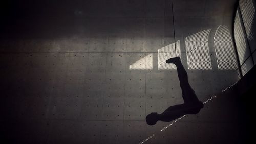 Silhouette man hanging in darkroom