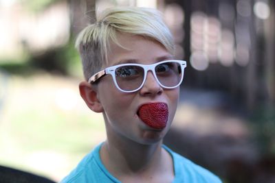 Portrait of boy with strawberry